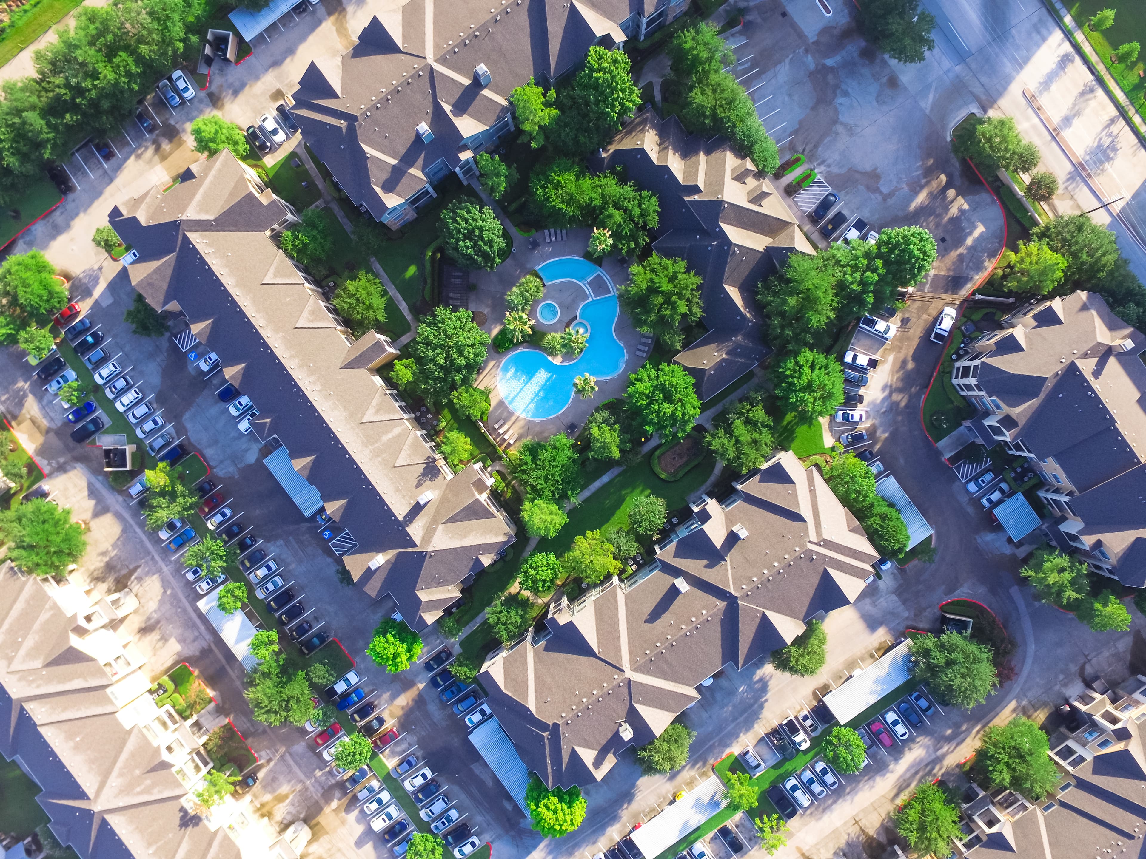 Aerial view of apartment complex with pool and multiple buildings