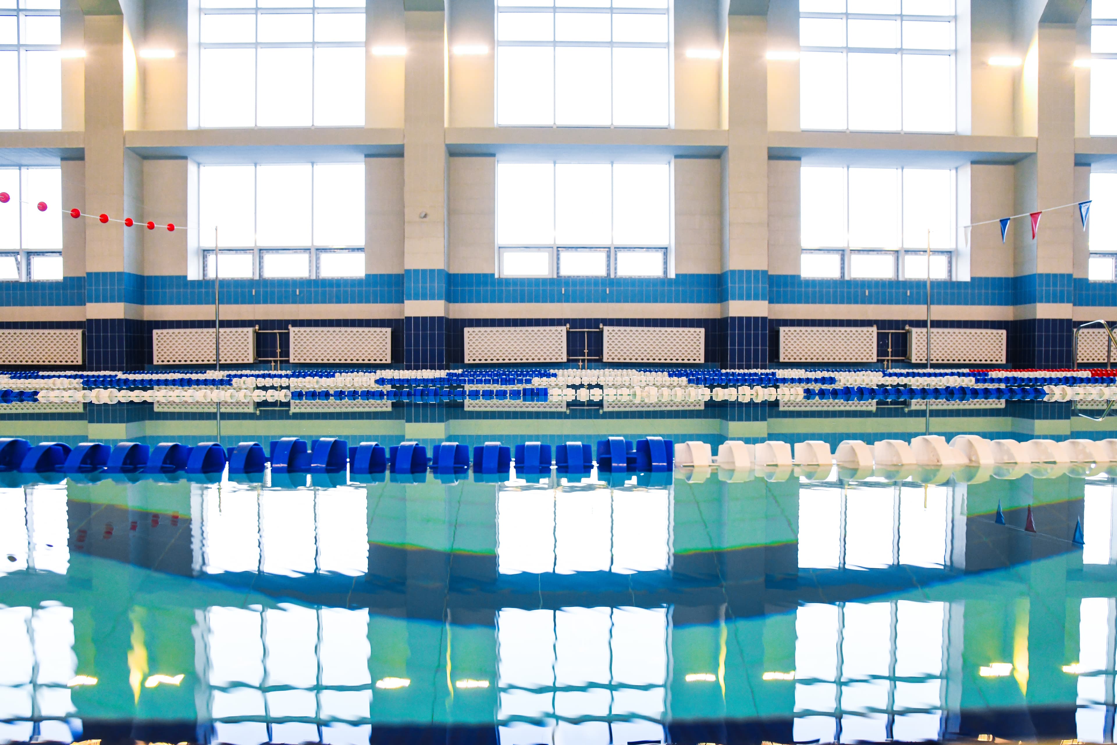 Indoor municipal pool with lane lines and competition flags