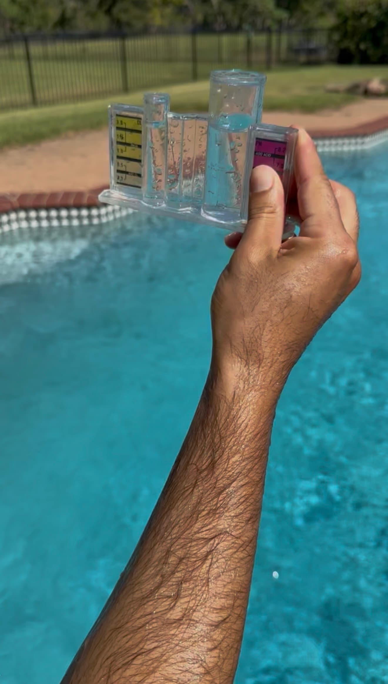 Pool technician testing water chemistry with professional test kit at Nashville residential pool