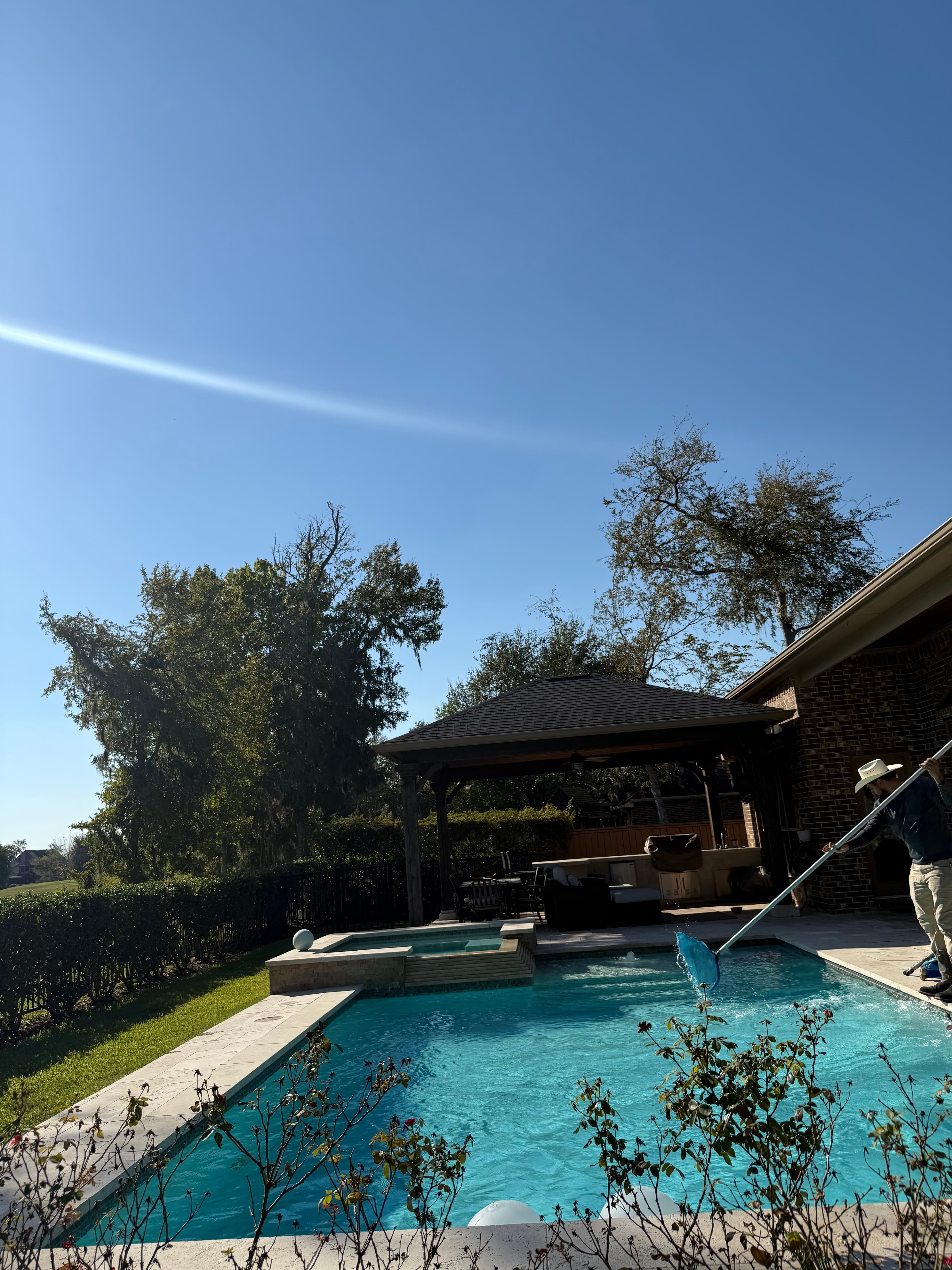 Pool technician brushing pool walls